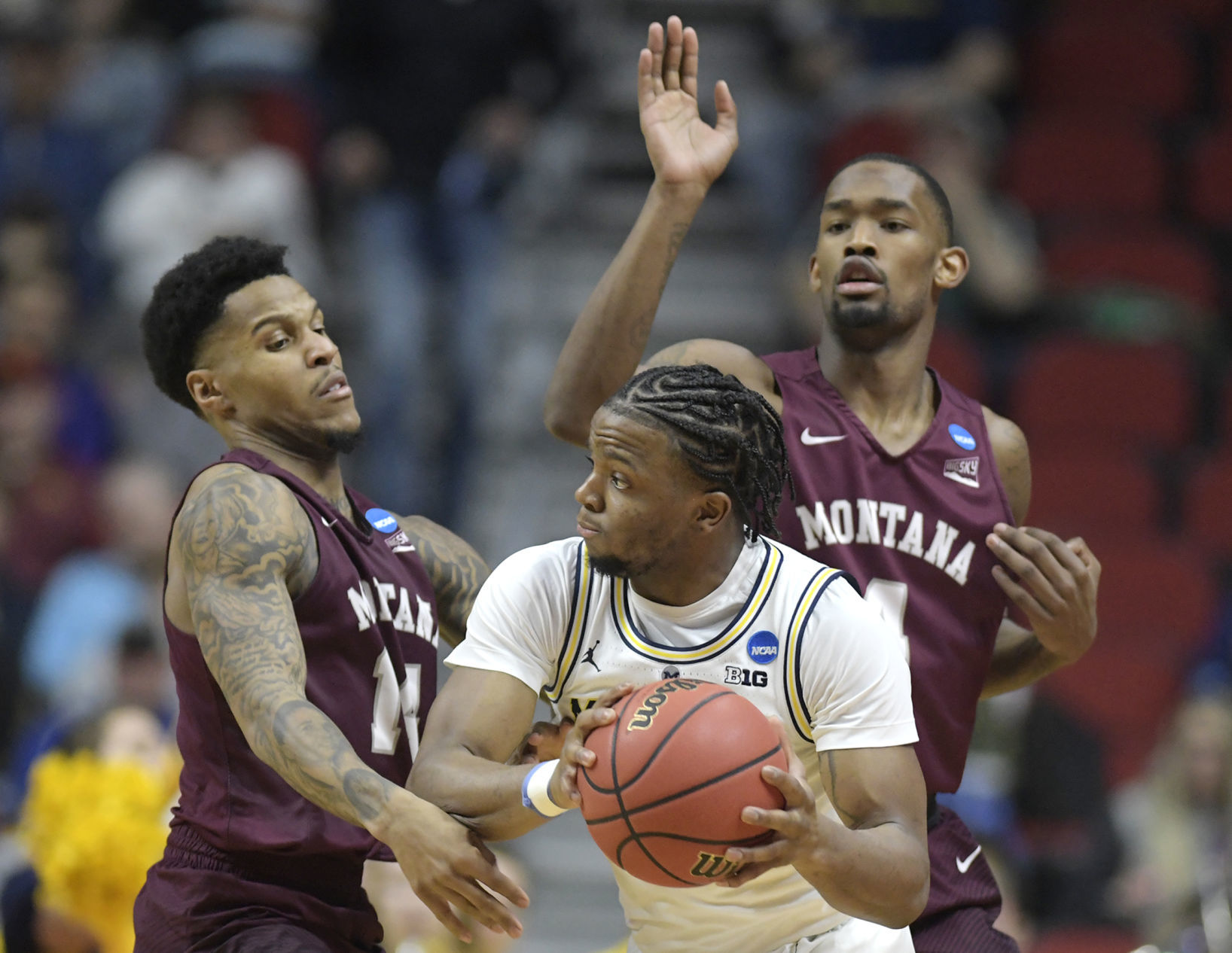 Zavier Simpson looks to pass around Montana's Ahmaad Rorie